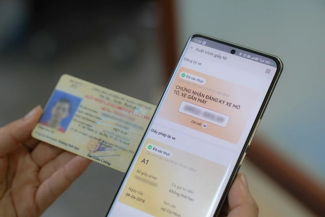 Người lái xe kiểm tra thông tin bằng lái xe bị CSGT giữ trên ứng dụng VNeID