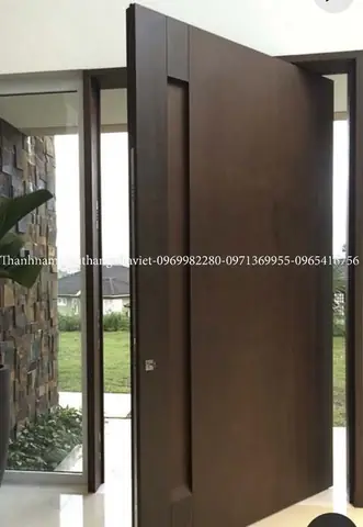 Mẫu Cửa Chính Biệt Thự Ms04 Là Lựa Chọn Hoàn Hảo Dành Cho Những Gia Chủ Yêu Thích Sự Đơn Giản, Tinh Tế Nhưng Vẫn Toát Lên Vẻ Sang Trọng Và Hiện Đại. Được Thiết Kế Với Chất Liệu Gỗ Cao Cấp Kết Hợp Cùng Kiểu Dáng Cửa Pivot (trục Xoay Giữa), Mẫu Cửa Này Mang Đến Sự Khác Biệt Hoàn Toàn So Với Những Thiết Kế Truyền Thống. Với Kích Thước Lớn, Đường Nét Phẳng Mịn Và Bề Mặt Gỗ Sang Trọng, Cửa Ms04 Tạo Nên Ấn Tượng Mạnh Mẽ Ngay Từ Cái Nhìn Đầu Tiên. Đây Chính Là Điểm Nhấn Giúp Nâng Tầm Không Gian Sống Và Khẳng Định Gu Thẩm Mỹ Tinh Tế Của Gia Chủ. Đặc Điểm Nổi Bật Của Cửa Chính Biệt Thự Ms04 1. Thiết Kế Trục Xoay (pivot Door) Hiện Đại Khác Với Cửa Bản Lề Truyền Thống, Ms04 Sử Dụng Trục Xoay Giữa, Giúp Việc Đóng Mở Nhẹ Nhàng, Linh Hoạt Và Tạo Hiệu Ứng Thẩm Mỹ Độc Đáo. Cánh Cửa Có Thể Xoay Mở Với Độ Rộng Lớn, Tạo Cảm Giác Bề Thế Và Đẳng Cấp. 2. Chất Liệu Cao Cấp – Bền Bỉ Với Thời Gian Cửa Ms04 Được Chế Tác Từ Gỗ Tự Nhiên Hoặc Gỗ Công Nghiệp Cao Cấp, Bề Mặt Xử Lý Chống Cong Vênh, Mối Mọt, Đảm Bảo Tuổi Thọ Lâu Dài. Lớp Sơn Phủ Mịn Sang Trọng Giúp Cửa Luôn Giữ Được Màu Sắc Đẹp Mắt Và Dễ Dàng Vệ Sinh. 3. Kiến Trúc Sang Trọng – Tạo Điểm Nhấn Cho Biệt Thự Với Kích Thước Lớn, Bề Mặt Phẳng Hiện Đại, Ms04 Dễ Dàng Hòa Hợp Với Nhiều Phong Cách Kiến Trúc Biệt Thự Từ Hiện Đại, Tối Giản Cho Đến Tân Cổ Điển. Đây Là Mẫu Cửa Giúp Tăng Tính Thẩm Mỹ, Đồng Thời Nâng Cao Giá Trị Tổng Thể Ngôi Nhà. 4. Đảm Bảo An Toàn – Tiện Ích Vượt Trội Cửa Chính Biệt Thự Ms04 Được Trang Bị Khóa An Toàn Đa Điểm, Bản Lề Âm Cao Cấp, Đảm Bảo Tính Chắc Chắn Và An Toàn Tuyệt Đối Cho Không Gian Sống. Đồng Thời, Thiết Kế Cửa Dày Dặn Còn Giúp Cách Âm, Cách Nhiệt Hiệu Quả, Mang Đến Sự Yên Tĩnh Và Thoải Mái Cho Gia Đình. Lợi Ích Khi Lựa Chọn Cửa Chính Biệt Thự Ms04 Tôn Lên Đẳng Cấp Của Ngôi Biệt Thự Ngay Từ Cái Nhìn Đầu Tiên. Thể Hiện Gu Thẩm Mỹ Hiện Đại Và Cá Tính Riêng Của Gia Chủ. Độ Bền Vượt Trội, Sử Dụng Lâu Dài Mà Không Lo Hư Hỏng. An Toàn – Tiện Nghi, Đảm Bảo Không Gian Sống Riêng Tư Và Yên Bình. Ứng Dụng Thực Tế Của Cửa Chính Ms04 Mẫu Cửa Chính Ms04 Phù Hợp Lắp Đặt Tại: Biệt Thự Hiện Đại, Nhà Phố Cao Cấp Khu Nghỉ Dưỡng, Resort Sang Trọng Không Gian Villa – Nhà Vườn Ở Bất Kỳ Công Trình Nào, Ms04 Cũng Mang Lại Sự Nổi Bật, Biến Lối Vào Trở Thành Điểm Nhấn Kiến Trúc Ấn Tượng. Kết Luận Mẫu Cửa Chính Biệt Thự Ms04 Là Lựa Chọn Lý Tưởng Cho Những Gia Chủ Muốn Sở Hữu Một Không Gian Sống Sang Trọng, Đẳng Cấp Và Khác Biệt. Với Thiết Kế Pivot Hiện Đại, Chất Liệu Cao Cấp Cùng Tính Năng An Toàn, Ms04 Không Chỉ Đơn Thuần Là Cánh Cửa Mà Còn Là Tác Phẩm Nghệ Thuật Nâng Tầm Giá Trị Ngôi Nhà.