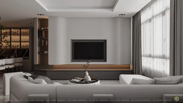 Phòng Khách Hiện Đại, Nổi Bật Bởi Mảng Tường Cong Ốp Tivi Tinh Tế Và Ánh Sáng Nhẹ Tạo Điểm Nhấn Ấm Áp, Sofa Ôm Trọn Không Gian, Mang Đến Cảm Giác Thư Giãn Và Sang Trọng